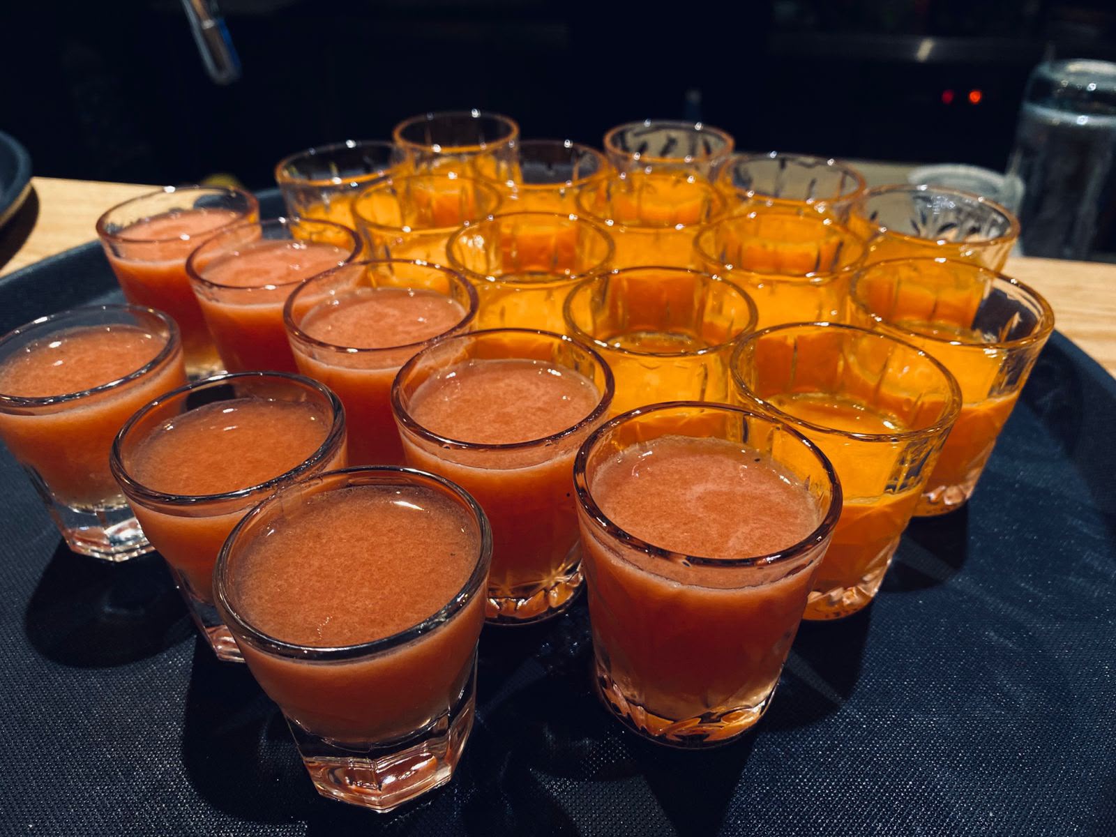 Tray of orange shots ready to serve