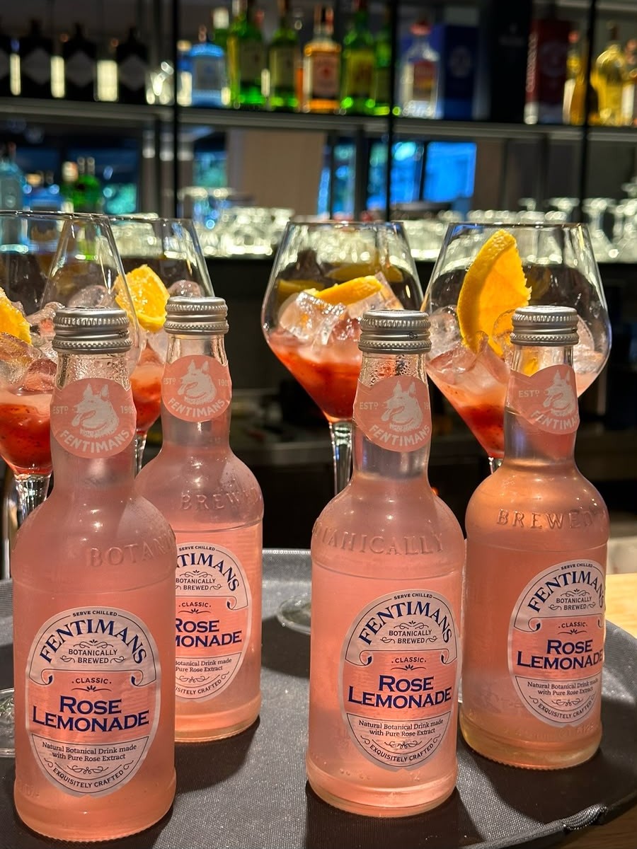 Chilled Fentimans Rose Lemonade with spritz glasses at the bar
