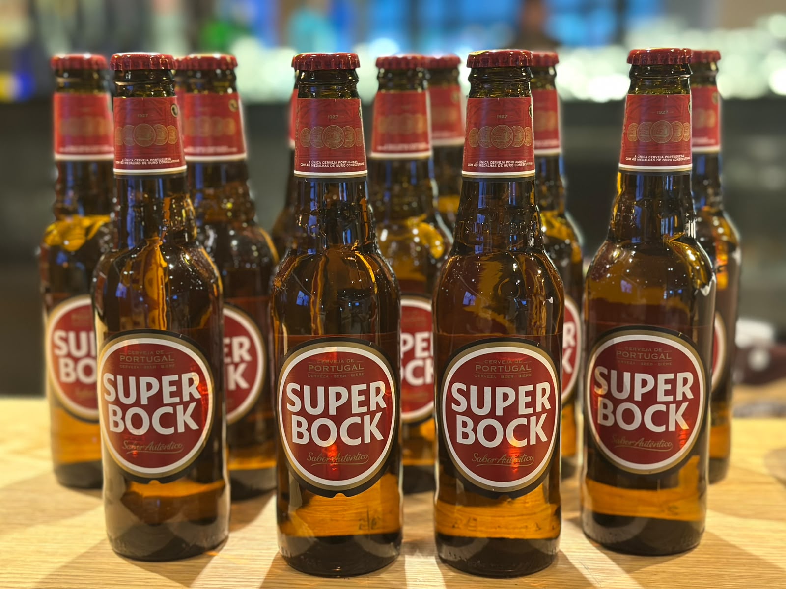 Super Bock beer bottles lined up on the bar